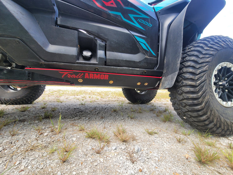 Trail Armor branded black slider nerf bar with red logo on Kawasaki KRX 1000 Special Edition side view