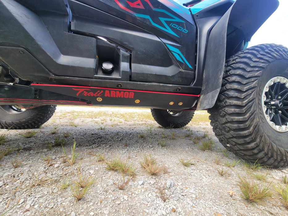 Trail Armor branded black slider nerf bar with red logo on Kawasaki KRX 1000 Special Edition side view