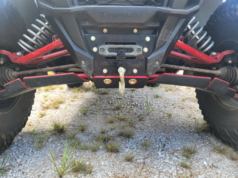 Trail Armor red front skid plate with winch mount installed on Kawasaki KRX 1000 outdoor terrain