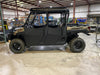 Trail Armor half doors on a camo Polaris Ranger Crew 1000 parked in a warehouse