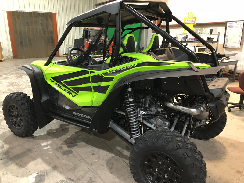 Trail Armor mud flap fender extensions installed on green Honda Talon 1000R UTV full side view