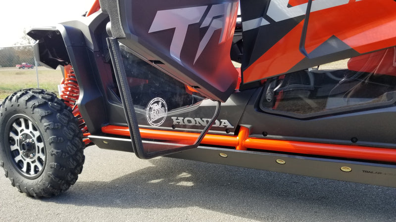 Trail Armor full skids rock slider and door area with logo badge on orange Honda Talon 1000X-4 Fox Live Valve 2020-2026