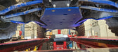 Trail Armor blue skid plate undercarriage view installed on Kawasaki KRX 1000 in shop