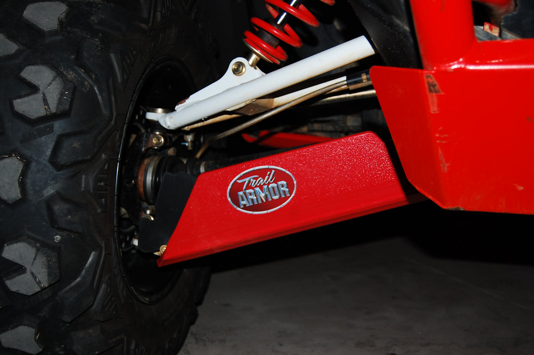 Trail Armor red A-arm CV boot guard with logo installed on a UTV rear suspension