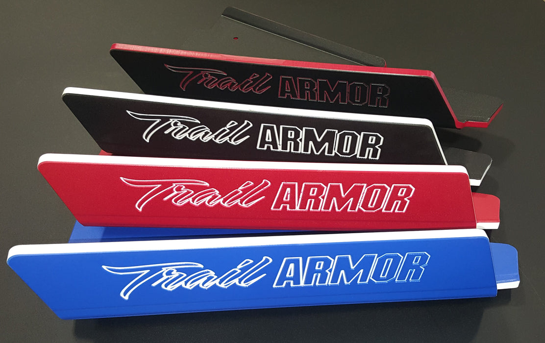 Trail Armor branded name plate emblems shown in red black and blue color options