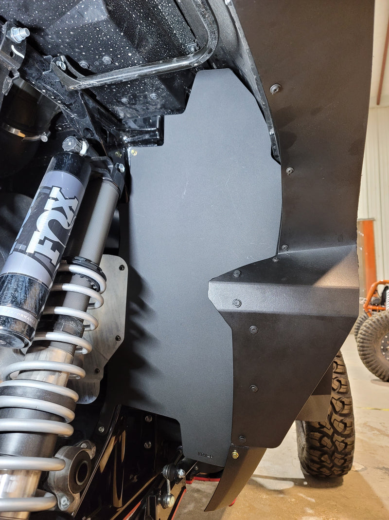 Trail Armor black inner fender liner full panel view with FOX shock on Kawasaki KRX 1000 in shop