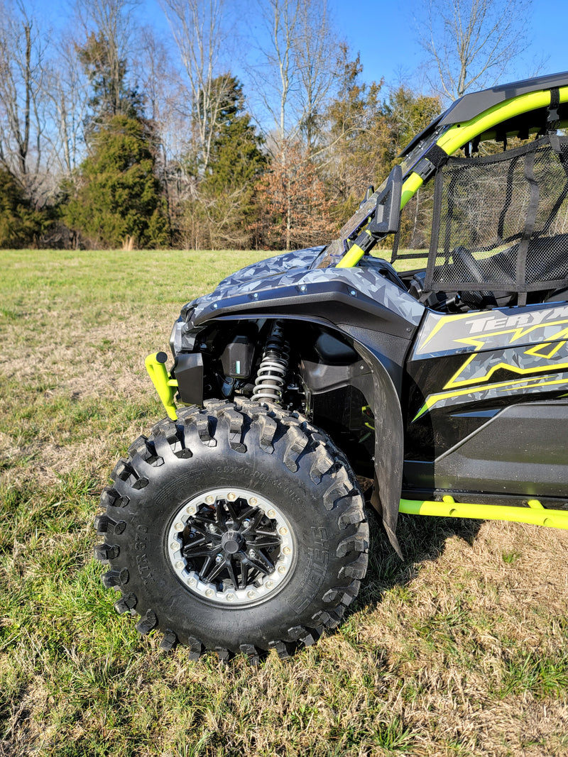 Trail Armor black mud flap fender extension front wheel arch close-up on Kawasaki KRX 1000 outdoors