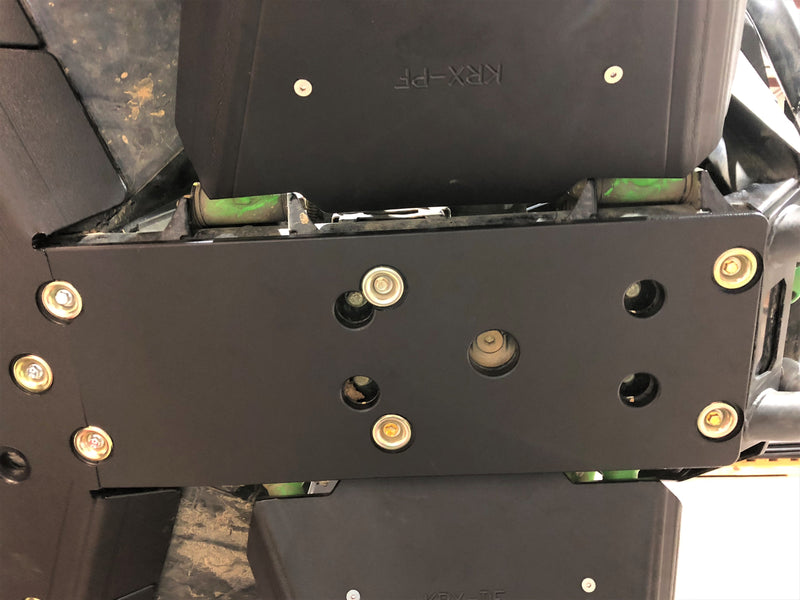 Trail Armor black skid plate close-up showing mounting hardware installed on Kawasaki KRX 1000