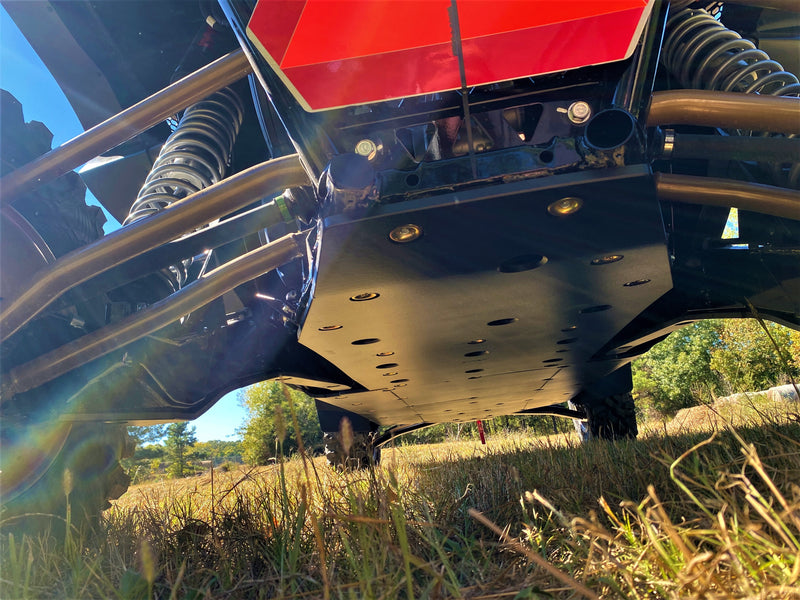 Trail Armor black full skid plates golden hour ground-level view on Kawasaki KRX 4 1000 outdoor field