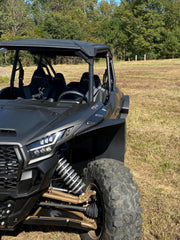Trail Armor black mud flap fender extension front quarter view on Kawasaki KRX 4 1000 outdoor field