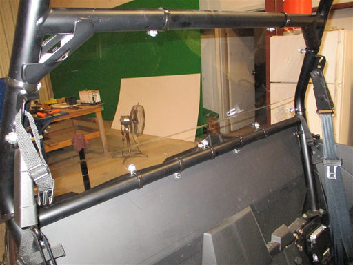 Trail Armor rear window dust shield mounting straps close-up on Polaris RZR cage bar