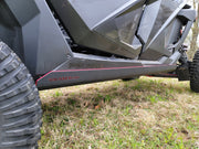 Close-up of Trail Armor skid plate branding on Polaris RZR Pro R 4 side