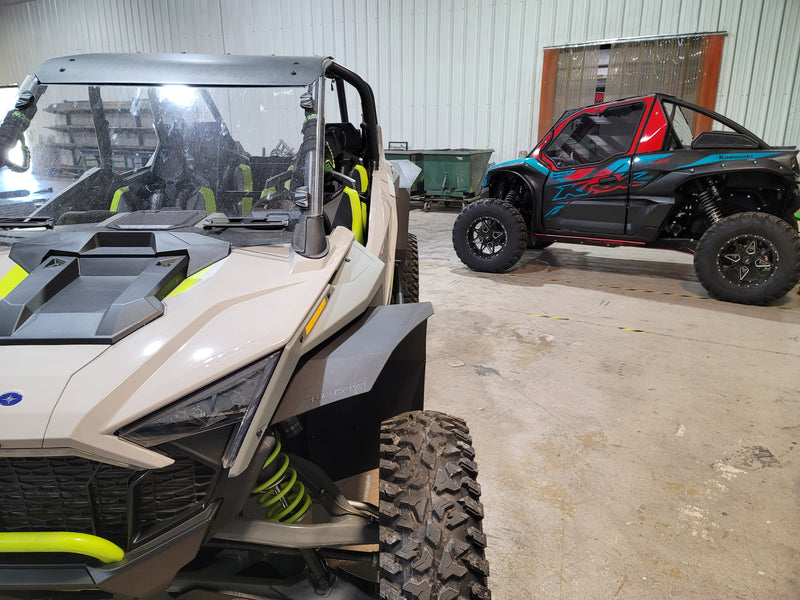 Trail Armor front fender flare on beige Polaris RZR Pro XP inside workshop