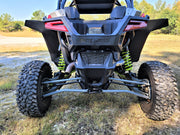 Trail Armor mud flap fender extensions installed on the rear of a Polaris RZR Pro XP, showing full coverage over the wide off-road tires