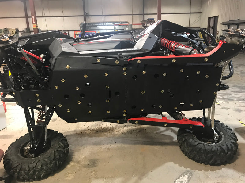 Trail Armor full skids installed on Polaris RZR RS1 undercarriage, side profile view 2018-2022