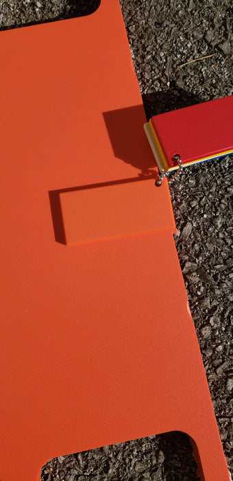 Trail Armor Super Tough Polymer skid plate shown in orange color option outdoors