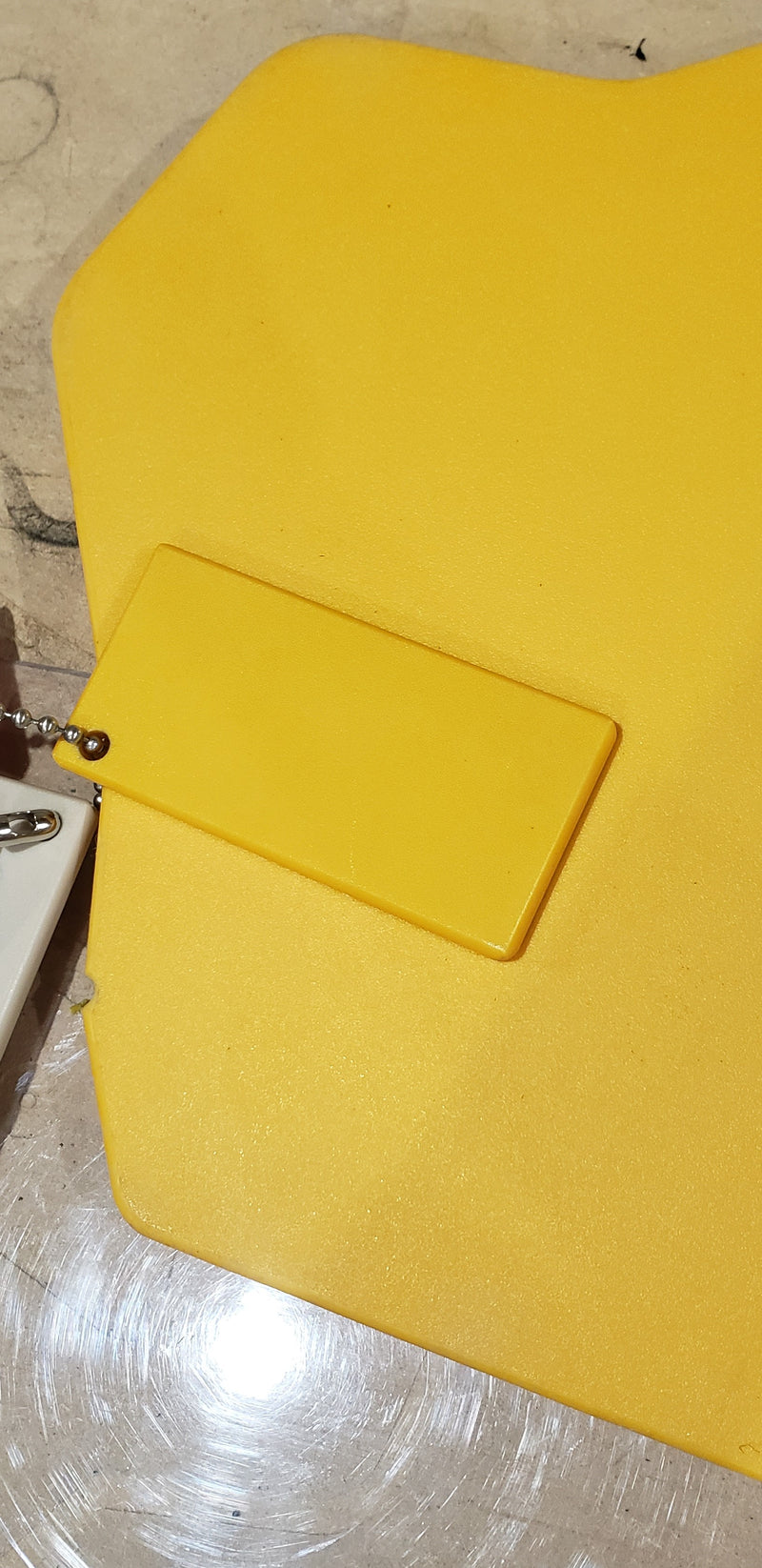 Trail Armor Super Tough Polymer yellow material sample with gauge tag